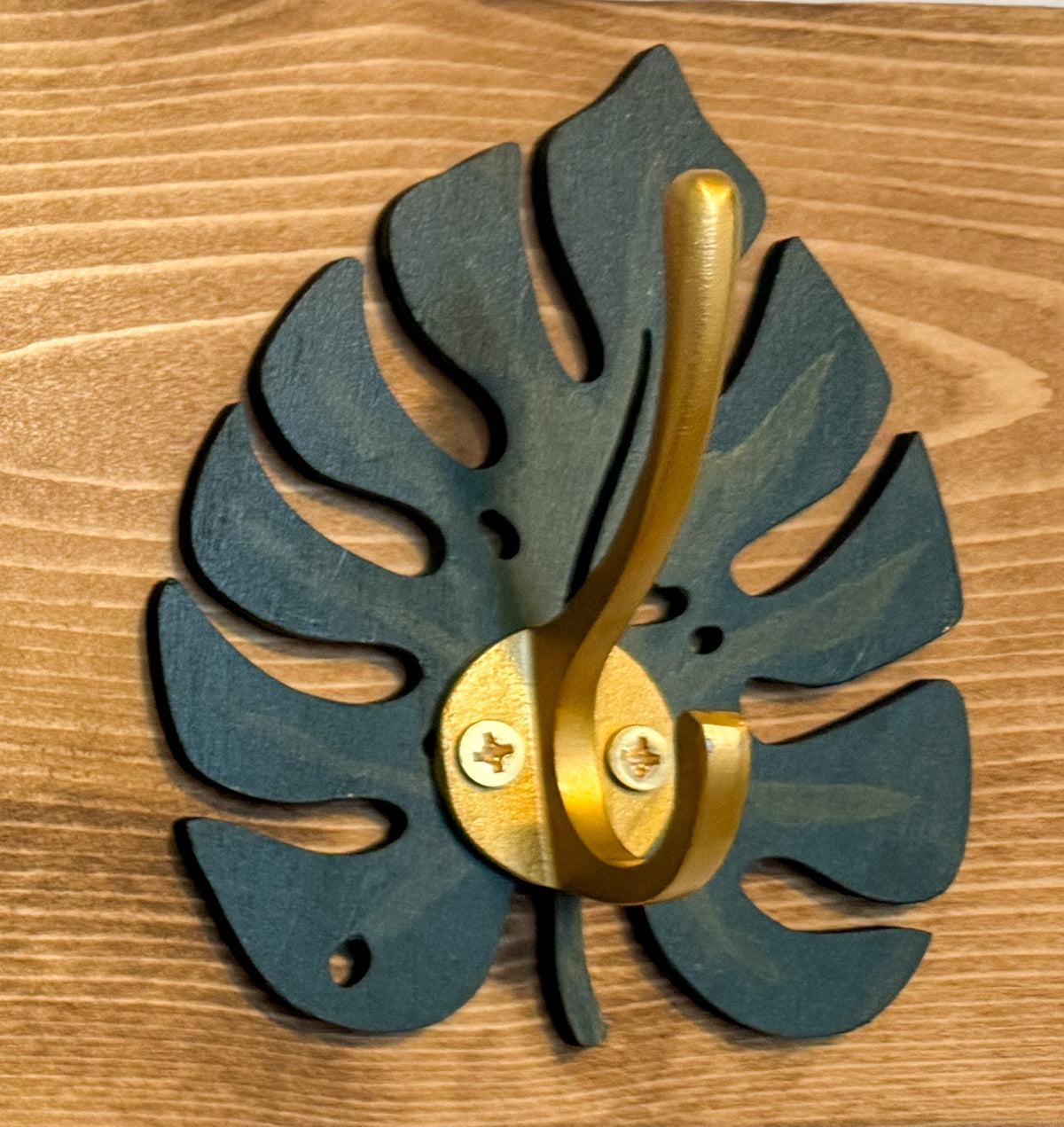 Monstera leaf hook rack with black hooks in driftwood finish