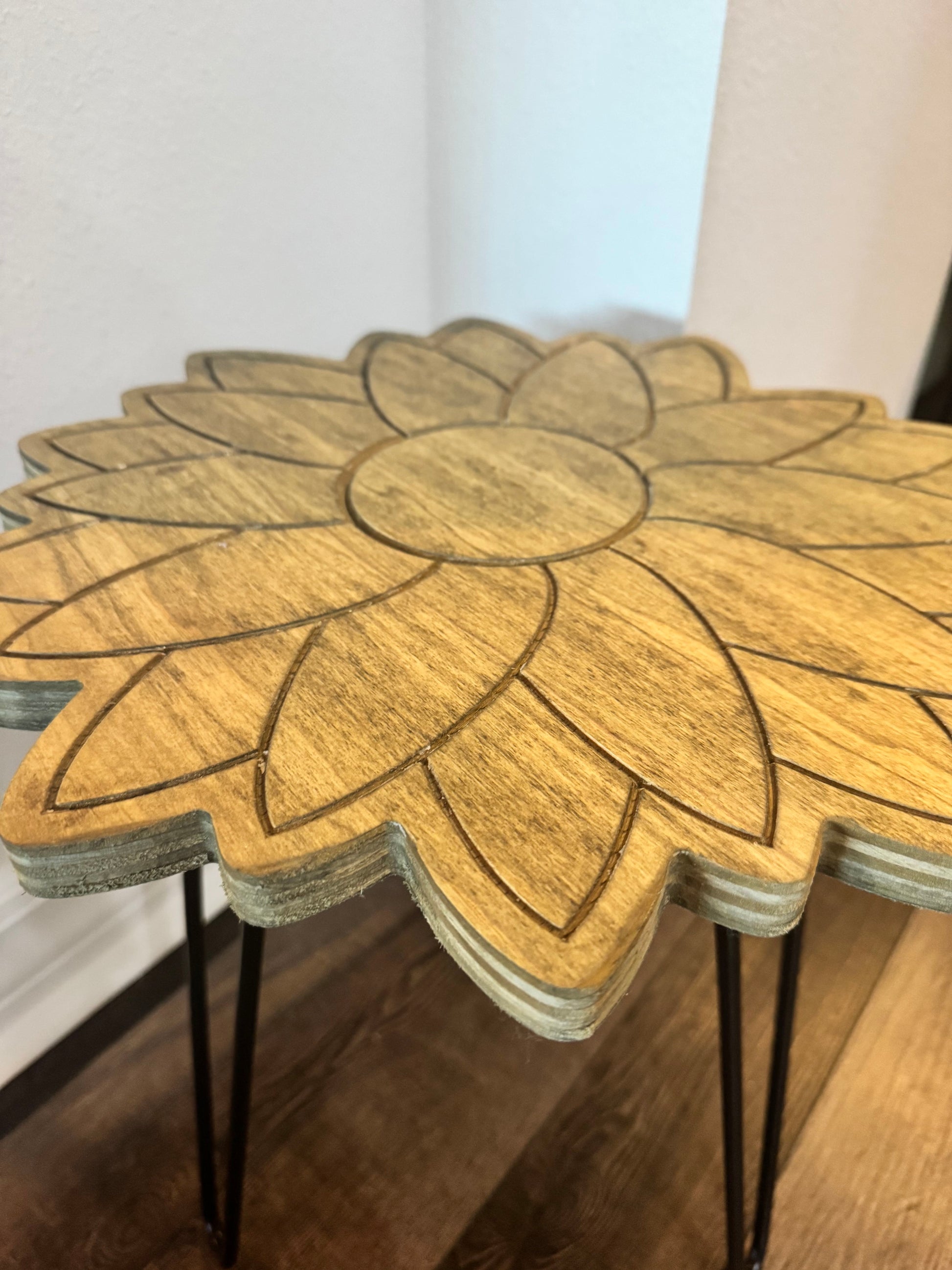 Handcrafted wooden sunflower plant stand with engraved petals and black hairpin legs