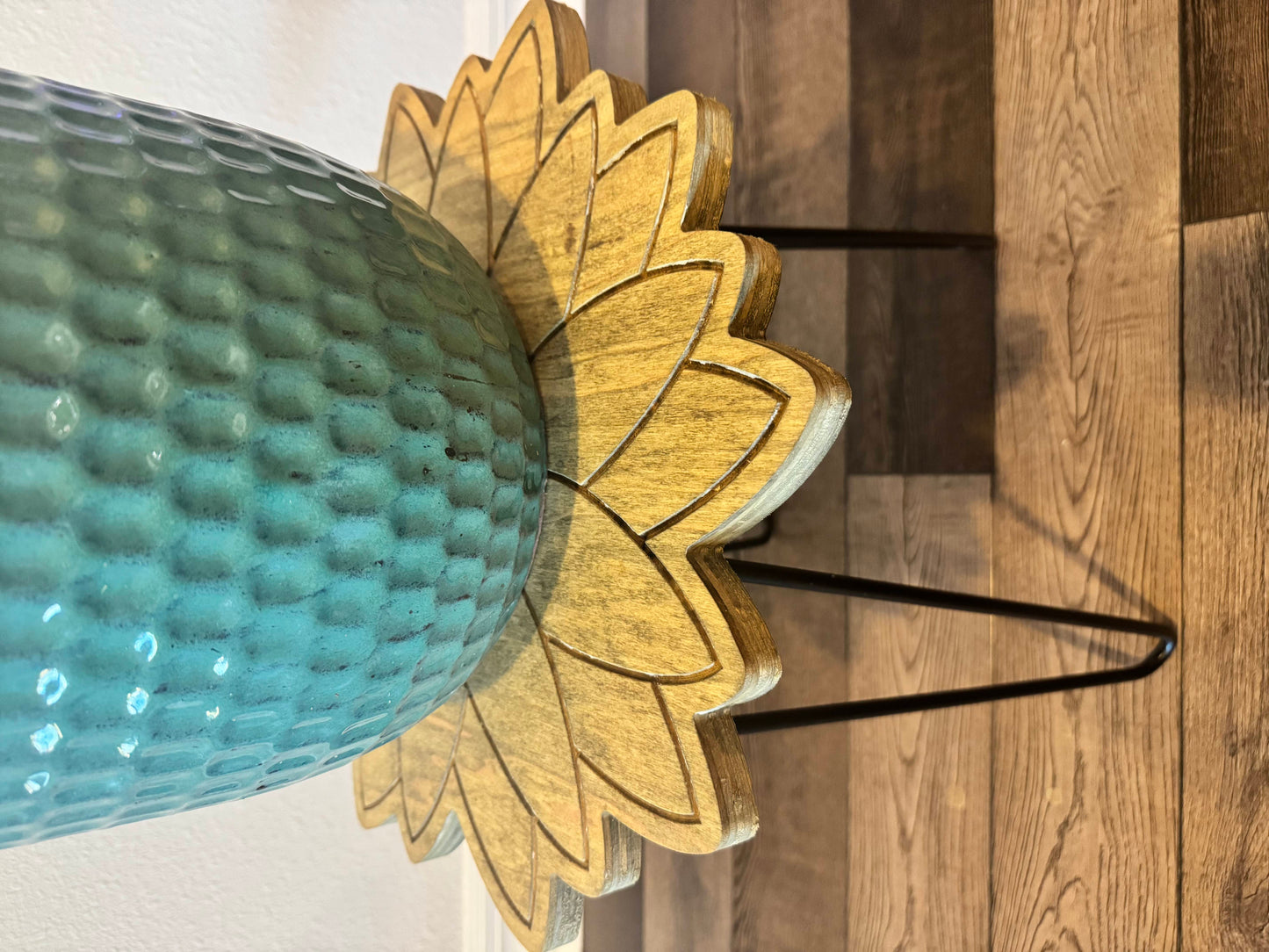 Wooden sunflower plant stand holding a blue ceramic planter