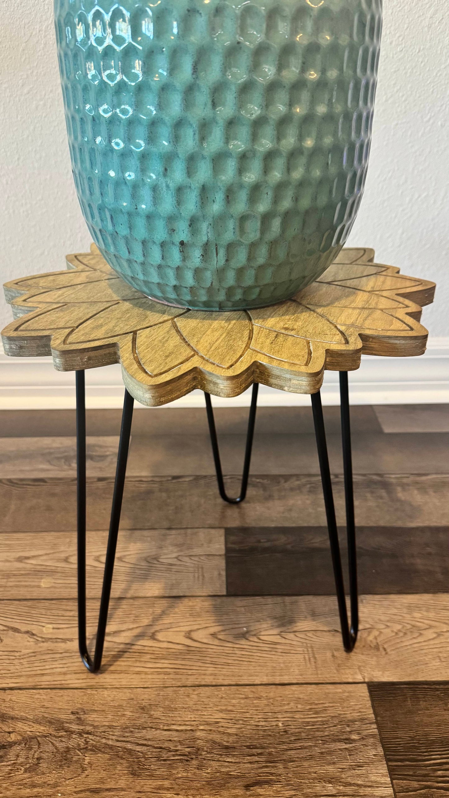 Side view showing the layered plywood sunflower edge and black hairpin legs