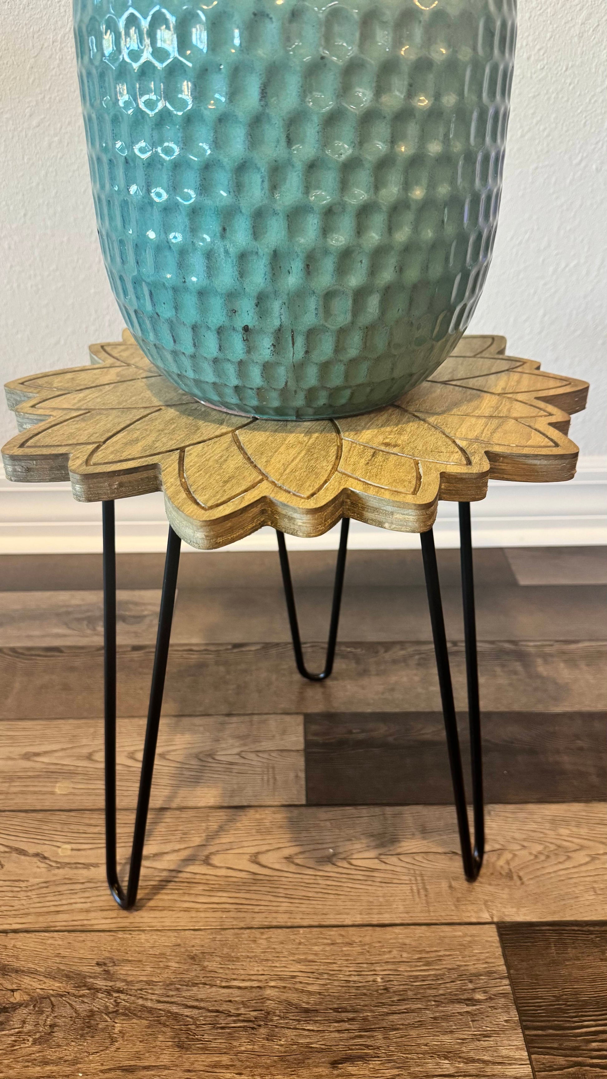 Side view showing the layered plywood sunflower edge and black hairpin legs