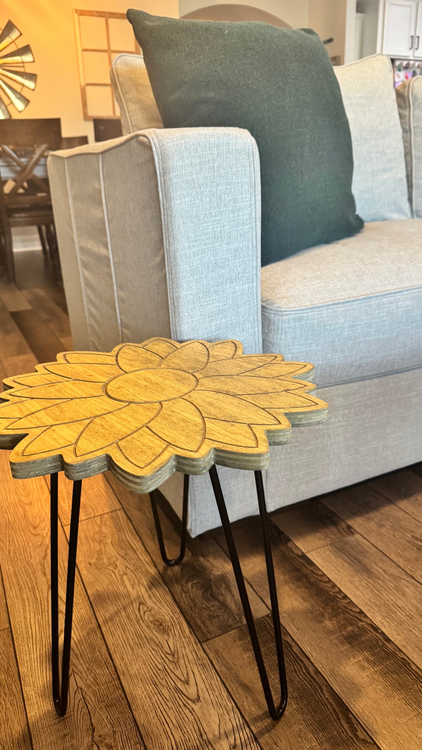 Sunflower plant stand styled beside a light gray armchair