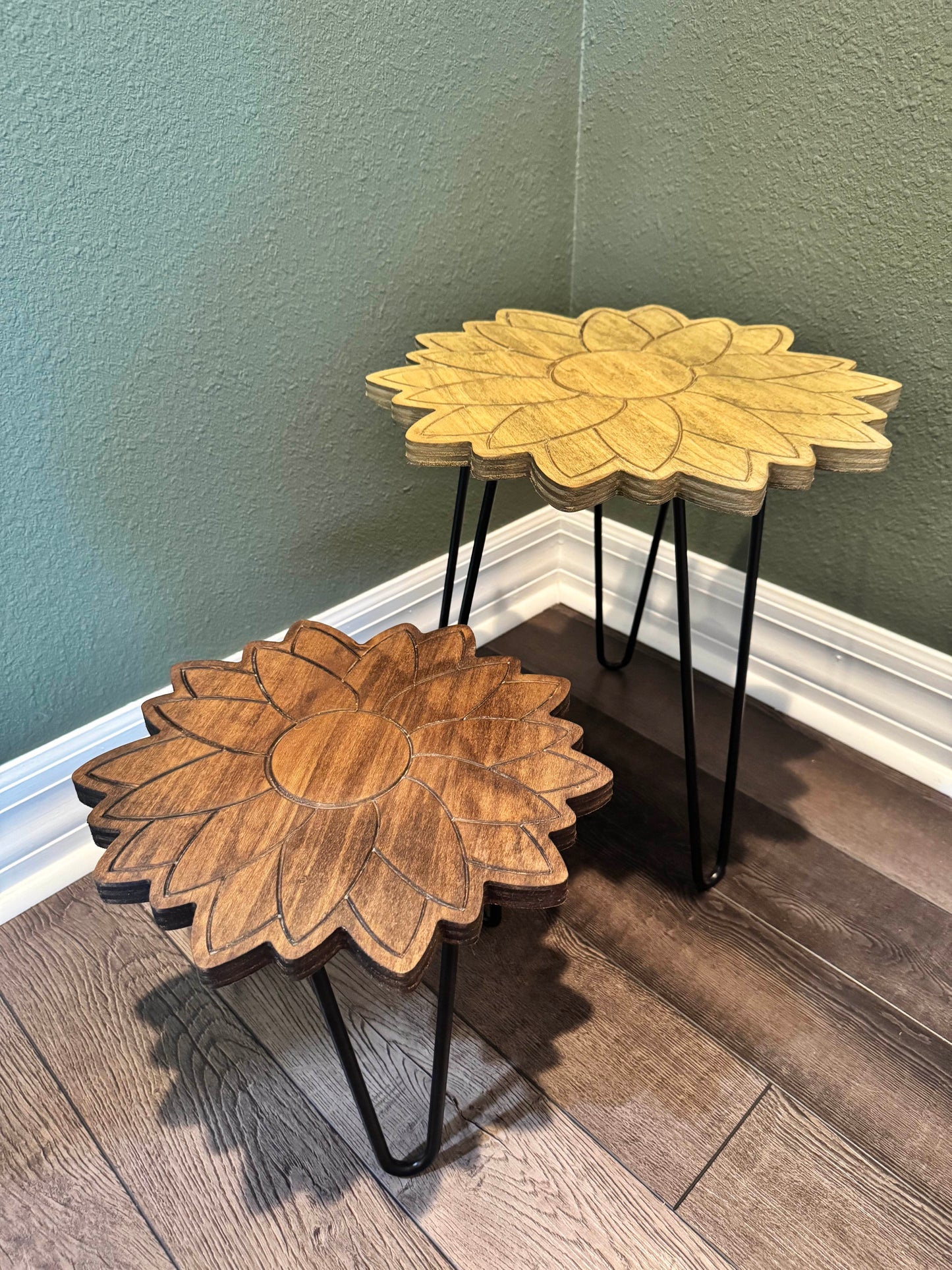 Sunflower plant stand displayed against a green wall